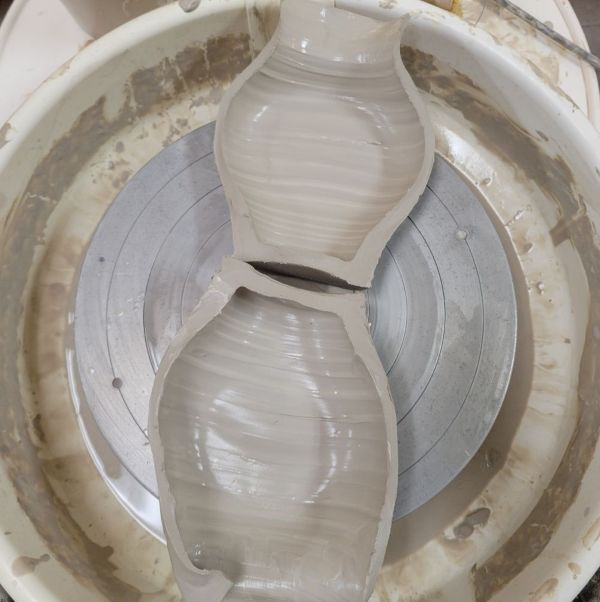 A vase on the potter's wheel, cut in half.