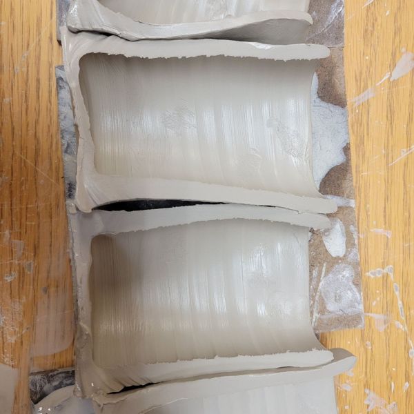 Greenware cylinders sliced in half.